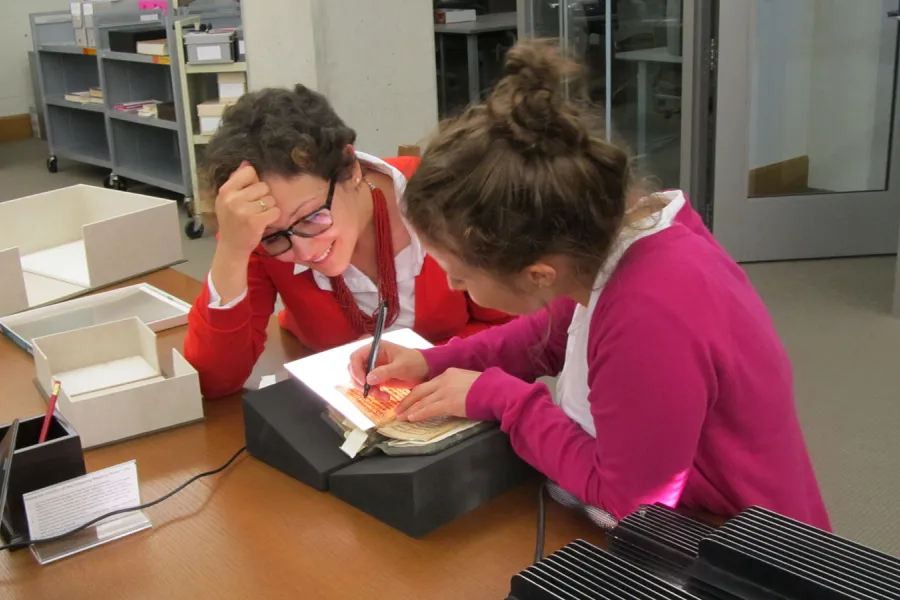 Two researchers transcribe old texts